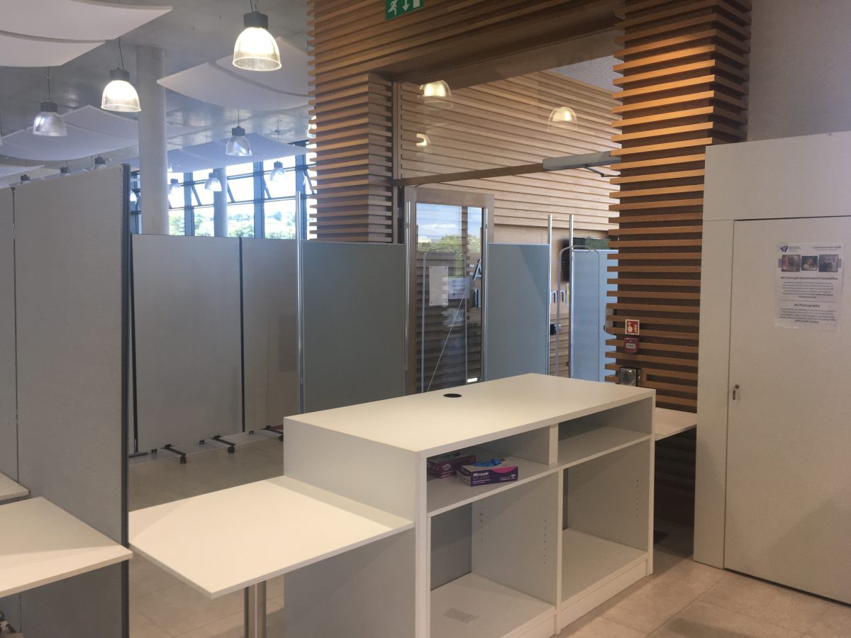 Temporary folding room divider with light grey fabric