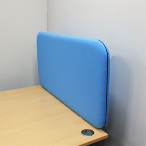 Acoustic desk divider attached to the side of an office desk