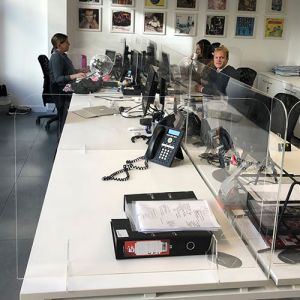 social distancing perspex desktop dividers positioned to the back and sides of the desktop